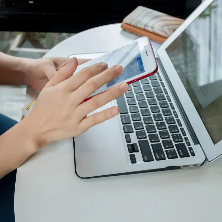 Women using smart phone with computer on the tab