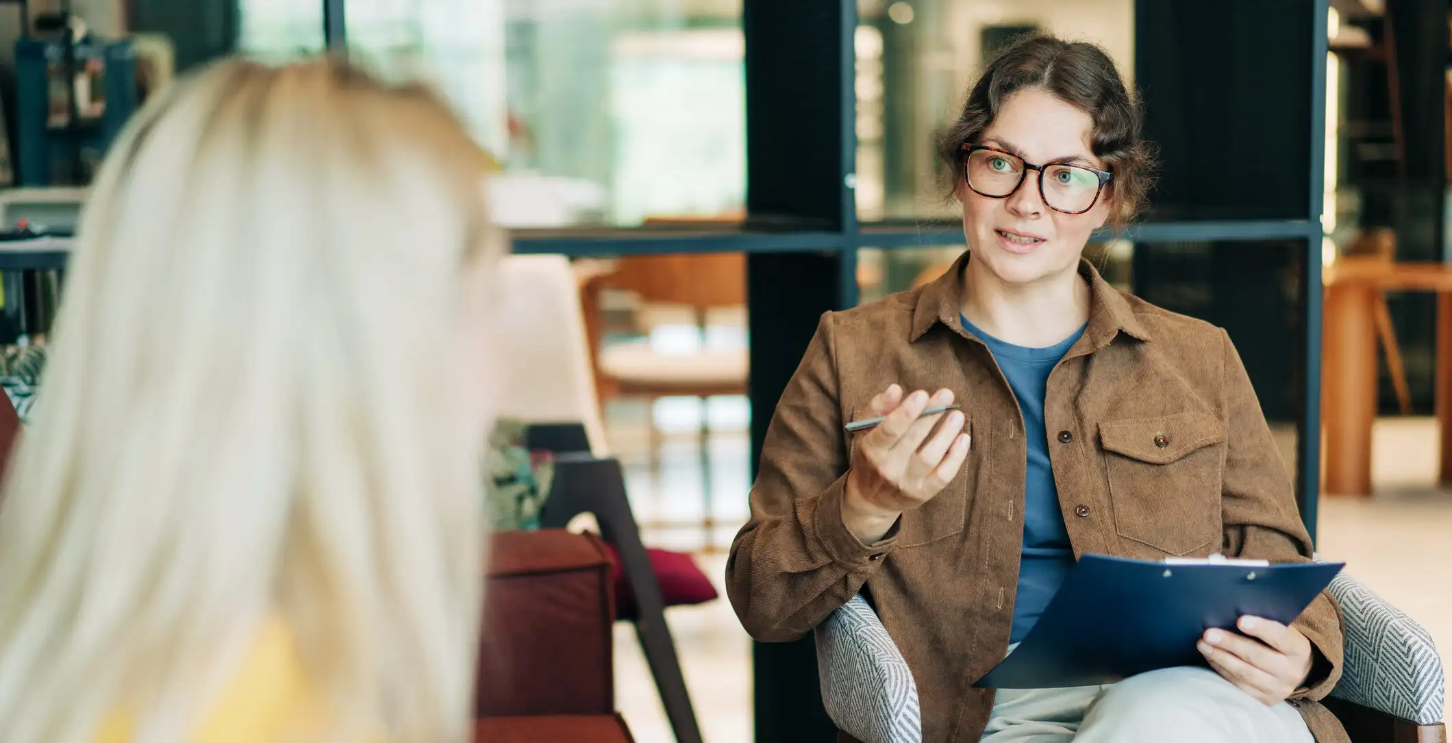 A female psychologist advises a client. Portrait of a professional modern woman. HR hires and conducts interviews.